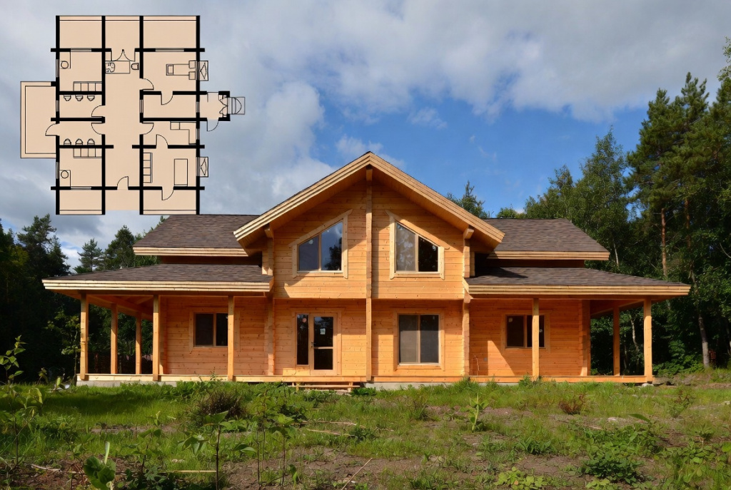 A photograph of a wooden house made of LVL beams, featuring a floor plan layout in a forested setting.